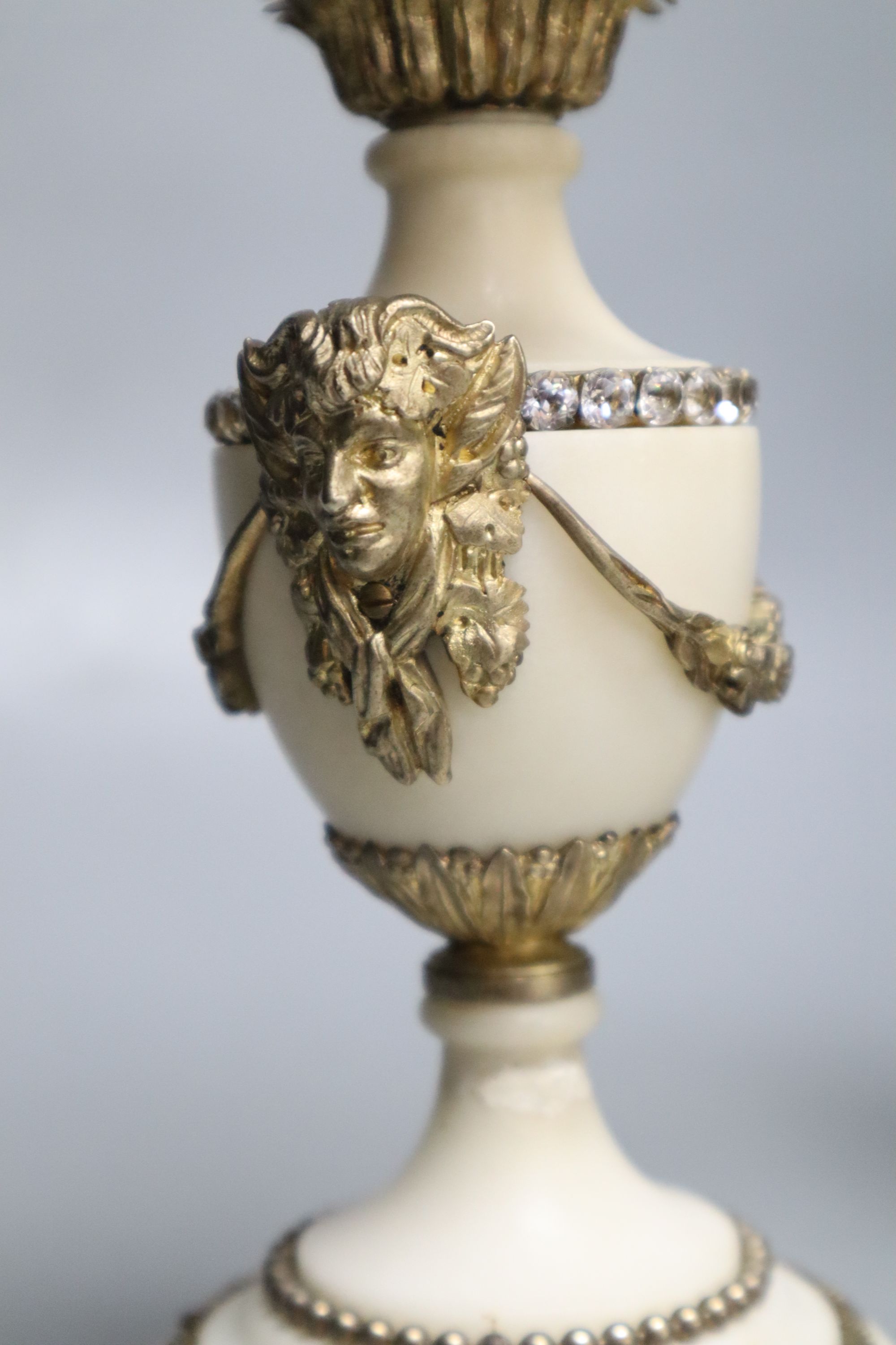 A pair of gilt metal and alabaster three branch candelabra, height 31cm (one a.f.)